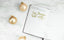 An Ink+Volt Planner sits on a desk with gold ornaments. The page reads”Big dreams, hard work”