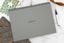 charcoal dashboard deskpad on marble surface
