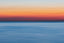 An array of horizontal sunrise colors, from blue to orange to white