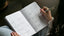 woman writing in goal planner
