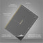 Black notebook with gold foil detail on a gray background, showing dimensions and features.