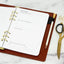 Ink+Volt 2025 Digital Planner PDF printed out in a small binder