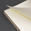 Open notebook with lined pages on a dark gray background